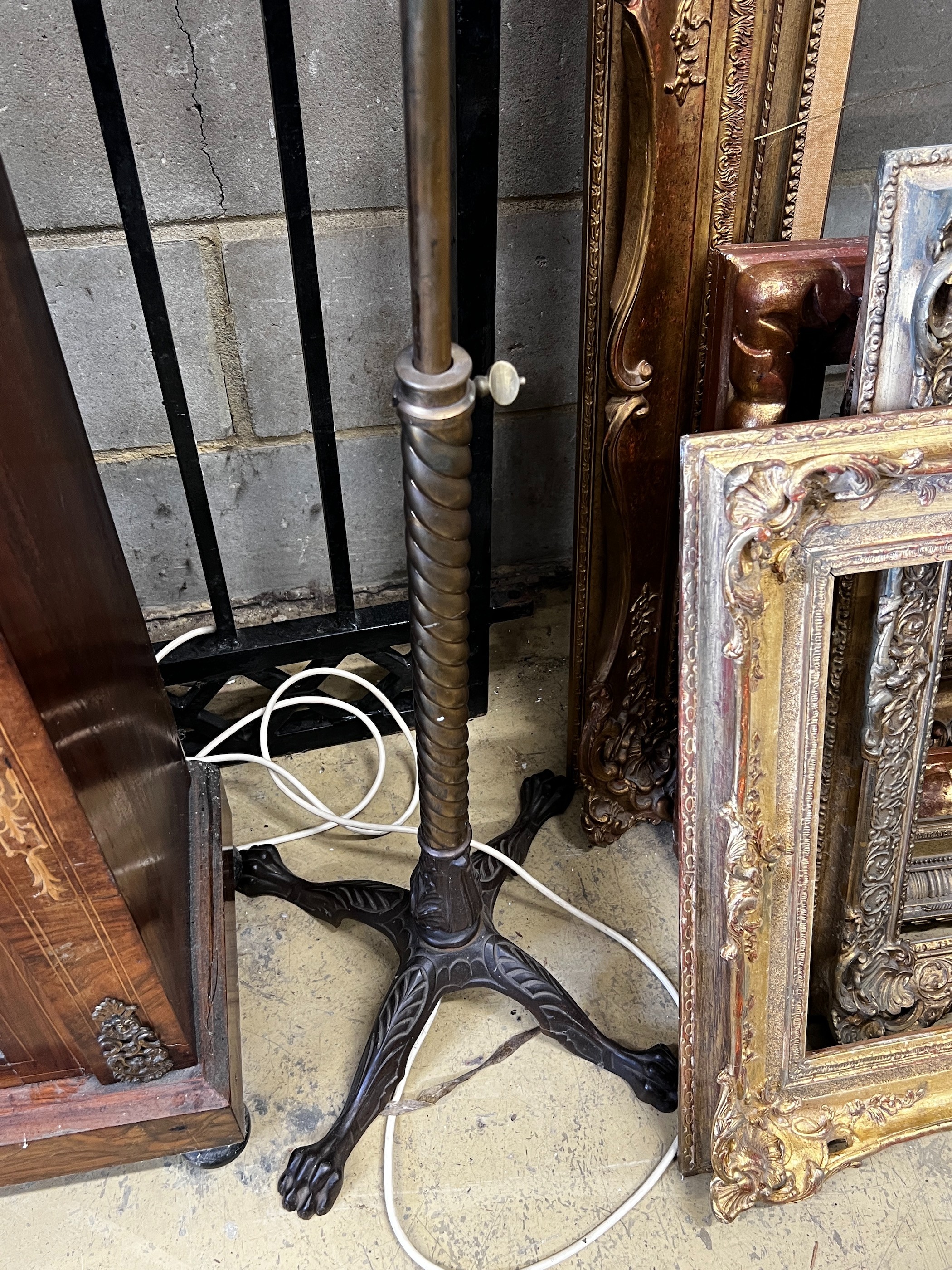A late Victorian brass oil lamp standard (converted) on associated telescopic cast iron stand, height 112cm